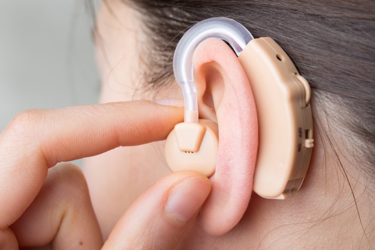 lose-up Of Hearing Aid In The Ear Of A Girl