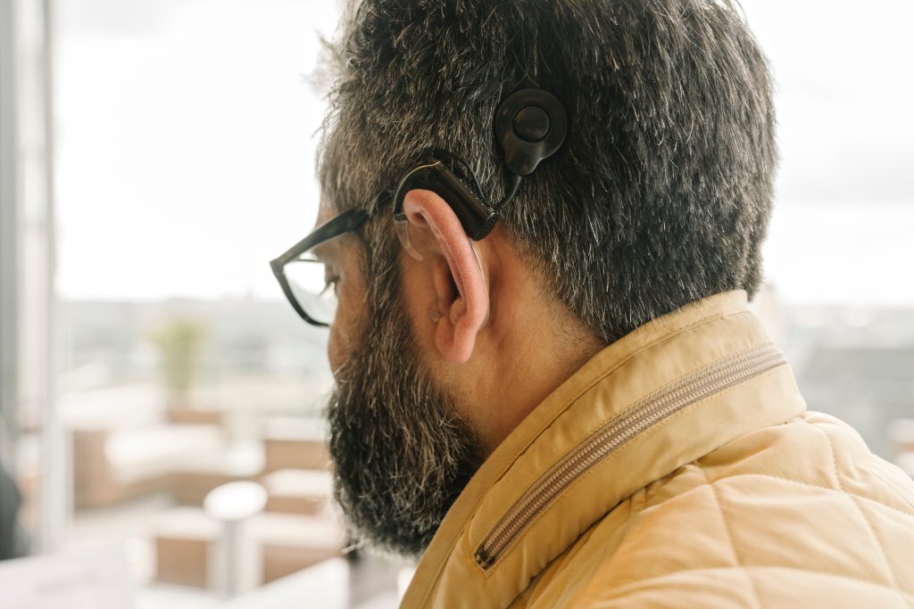 Profile of a man with cochlear implant