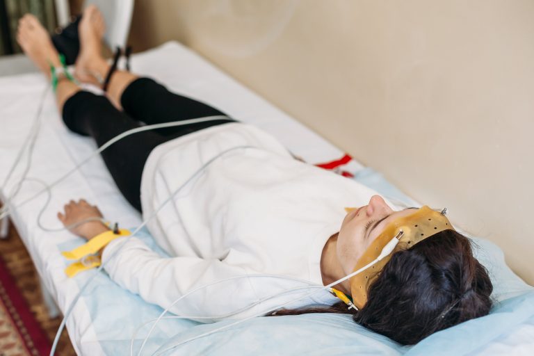 a woman undergoing a sleep study while lying down